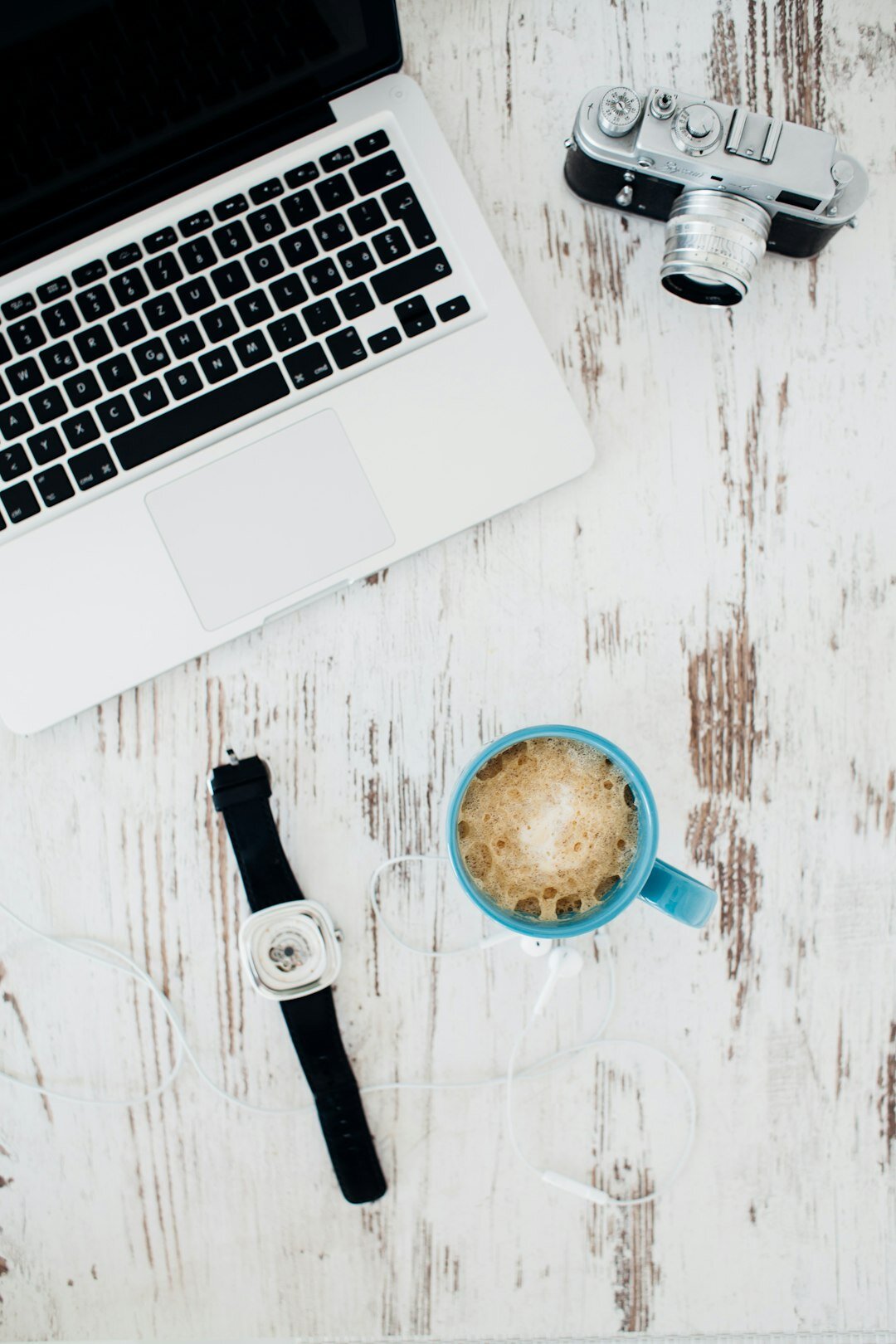 Top-down view of a desk with a laptop and coffee