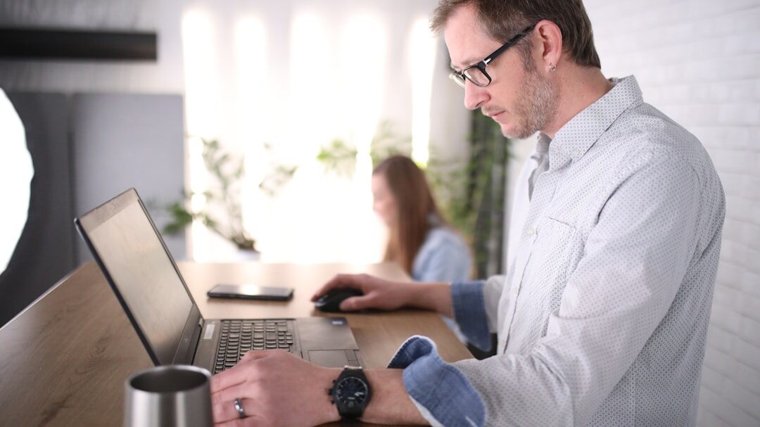 Business person typing on a laptop at a desk